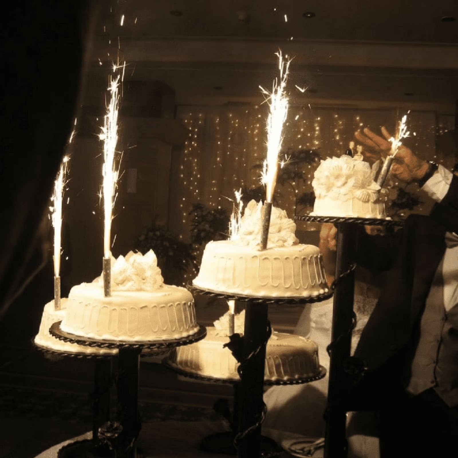 Single gold sparkler candle on Christmas cake